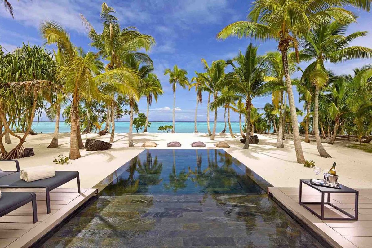 A luxurious villa pool looks over the ocean